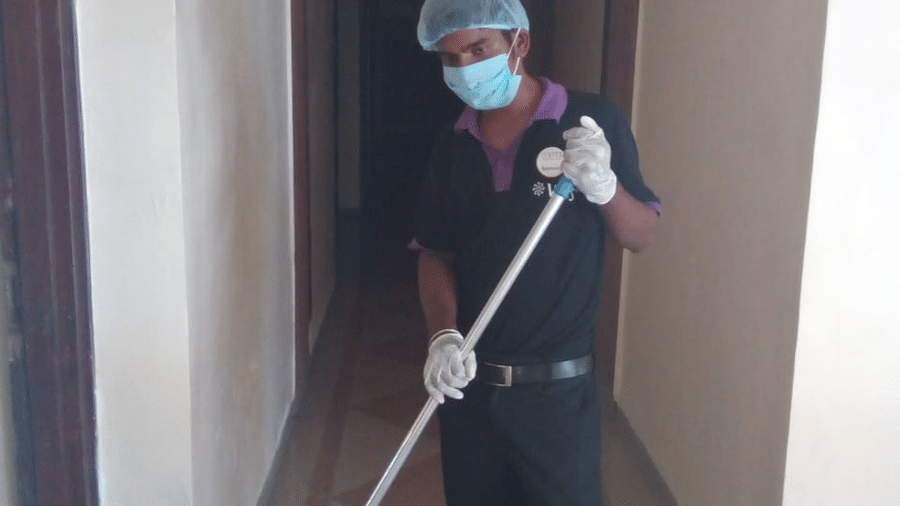 a staff member cleaning the corridor at one of the hotels - VITS Hotels & Resorts