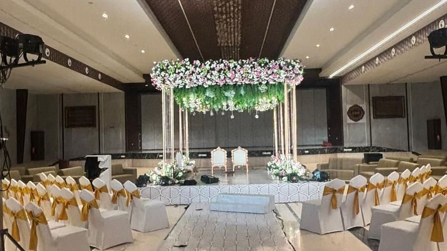 A wide-angle view of the hall featuring a combination of sofa seating and banquet chairs, with decorations throughout.