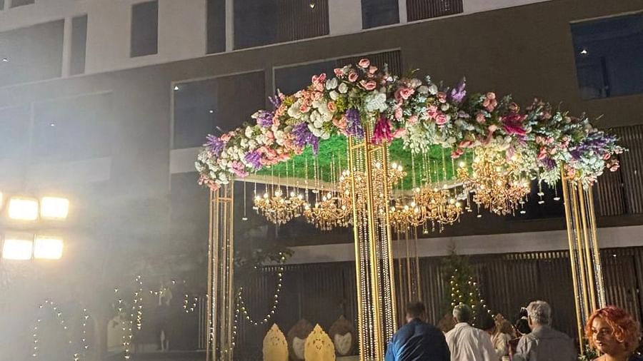 Nighttime view of a beautifully decorated wedding venue with twinkling lights.