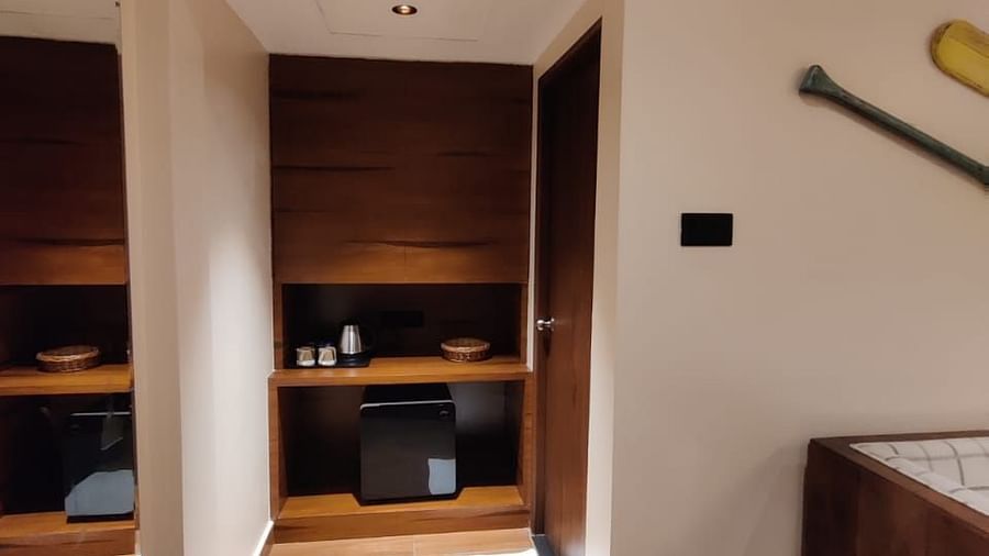 Cosy room with an open wardrobe, wooden furniture, and air-conditioning unit - Arina Island Resort, Swaraj Dweep