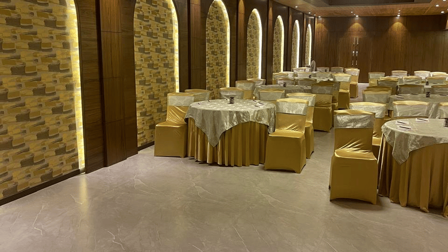 Jasmine Hall at Best Western Plus Revanta Resort & Spa featuring round tables, chairs, arched wall panels, and soft lighting.