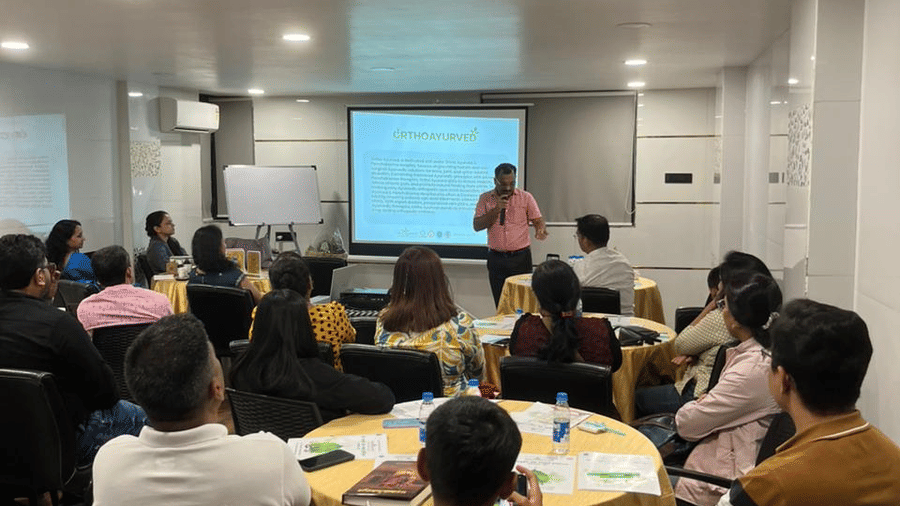 Conference room with guests seated for a meeting or presentation in a professional setting.