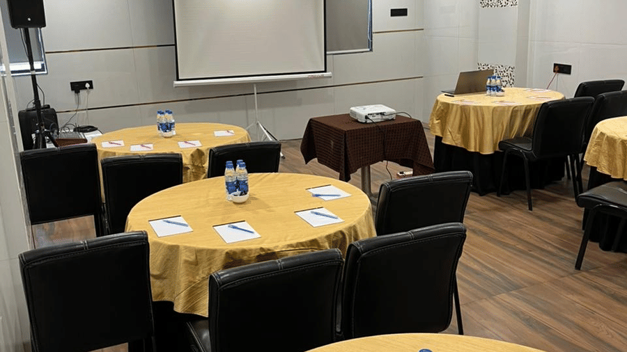 Well-equipped conference room with round table seating, suitable for meetings and corporate events.
