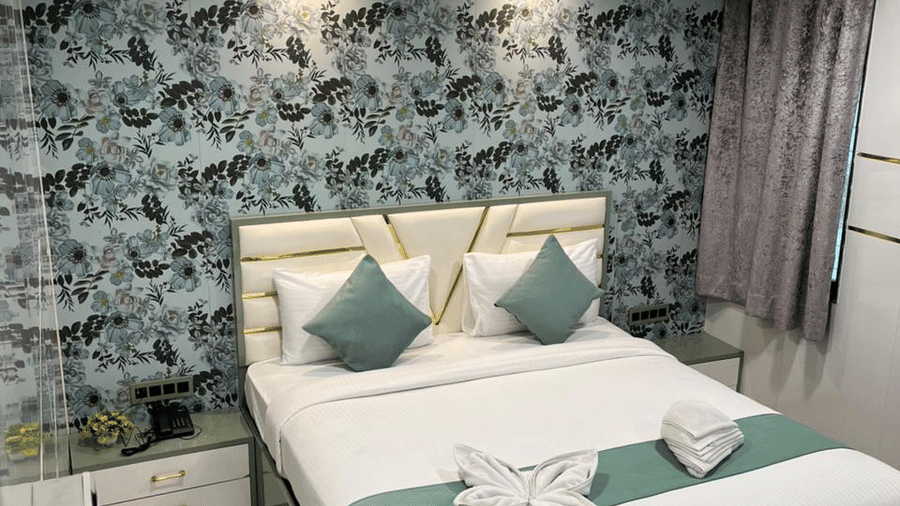 Deluxe hotel room with a double bed, stylish interiors, and a cosy ambience.