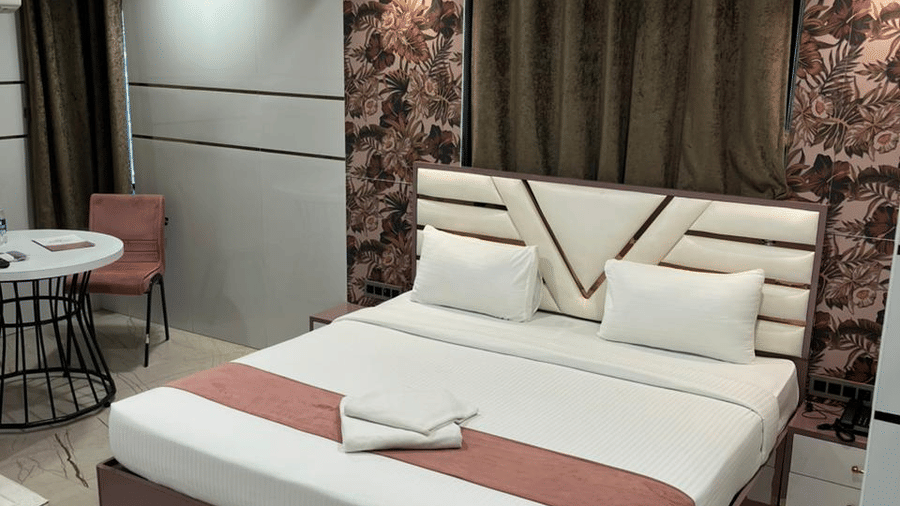 Comfortable deluxe room with a double bed, warm lighting, and elegant interiors.