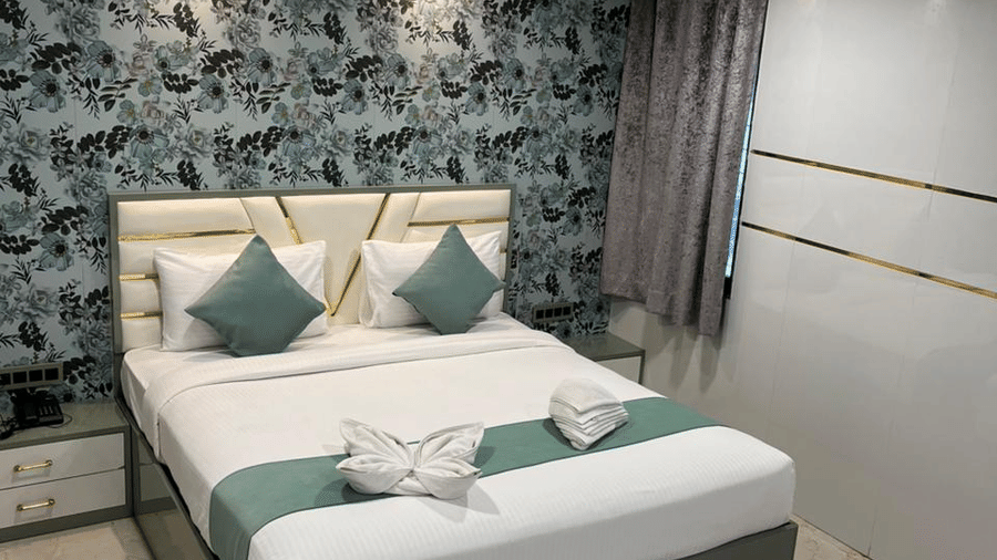 Premium hotel room with a large bed, stylish interiors, and cosy ambience for a restful stay.