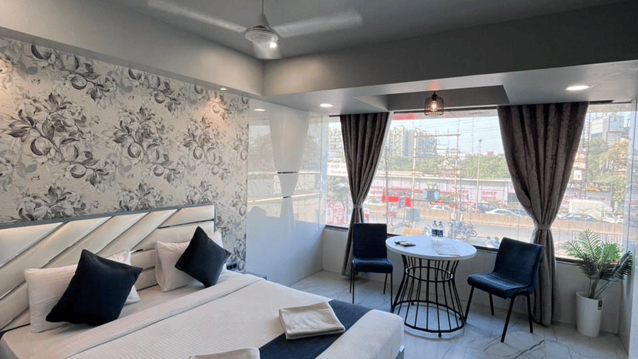 Modern twin-bed hotel room with elegant décor, comfortable bedding, and natural lighting.