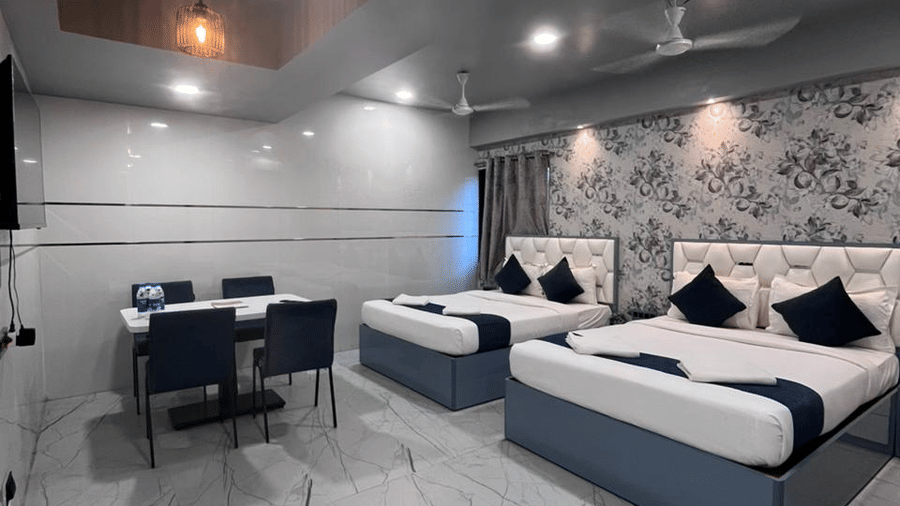 Twin-sharing hotel room with comfortable beds, contemporary design, and soft lighting.