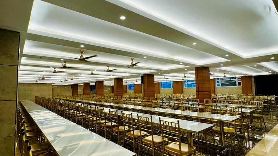 Image of a hall with neatly arranged tables and chairs at Le Royale Palace.