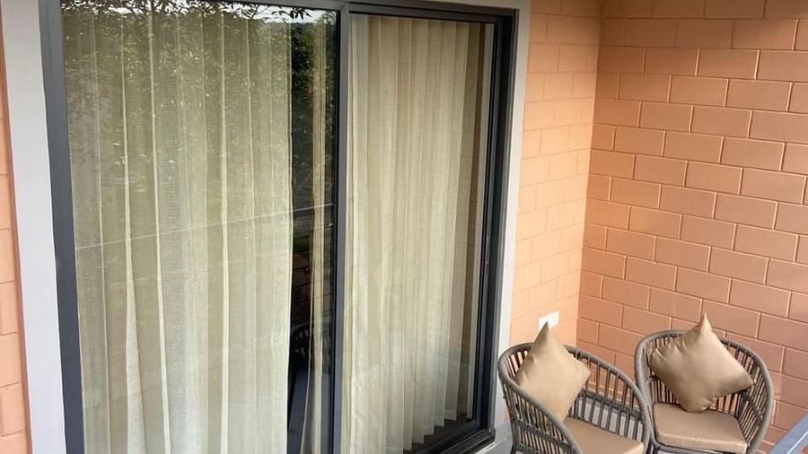 The balcony area of the Harmony room with chairs placed on the car at Trishvam Symphony, Krishnagiri.