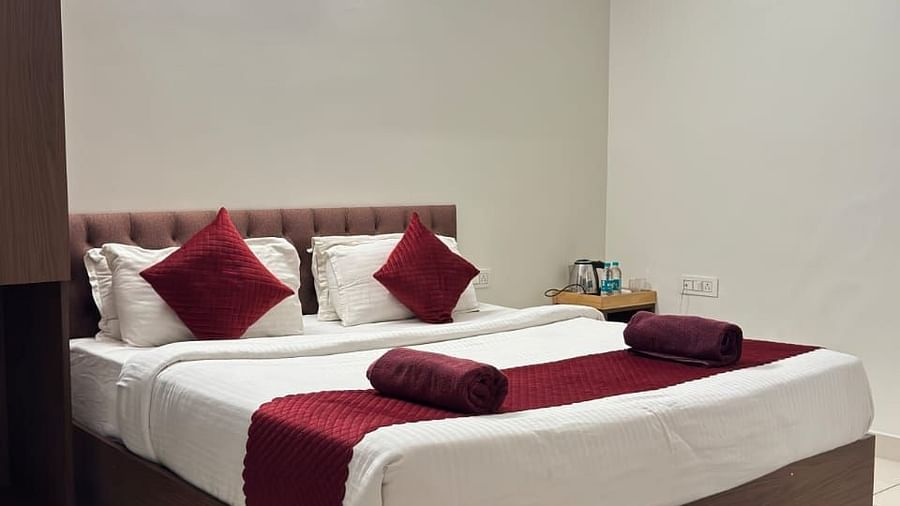 A bed with plush bedding in a bedroom | Vistar Resort, Bengaluru