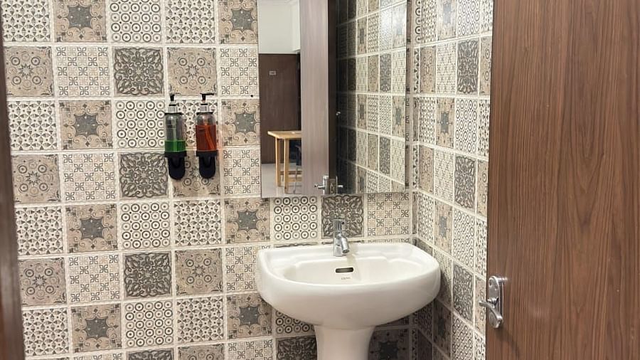 A bathroom featuring patterned tiles and a pedestal sink | Vistar Resort, Bengaluru