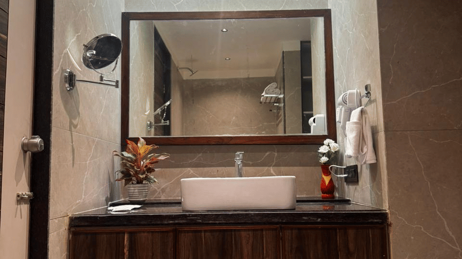 Spacious triple room with clean white linens and warm lighting - Lords Swastik Studio, Kodinar