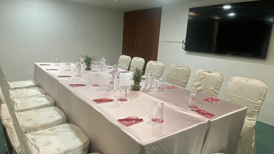 A banquet hall with a TV and ceiling lights