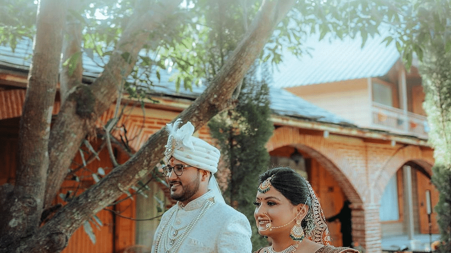 The bride and groom walking along at The Sylvan Retreat, Dehradun.
