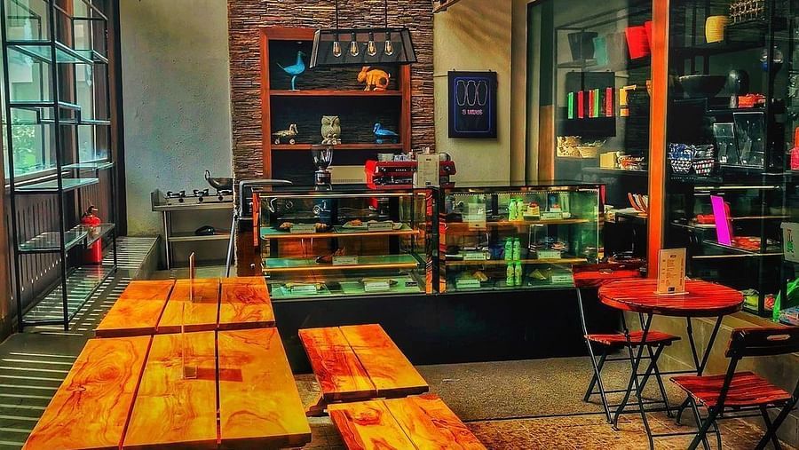 an overview of a bakery with seating arrangements in the foreground