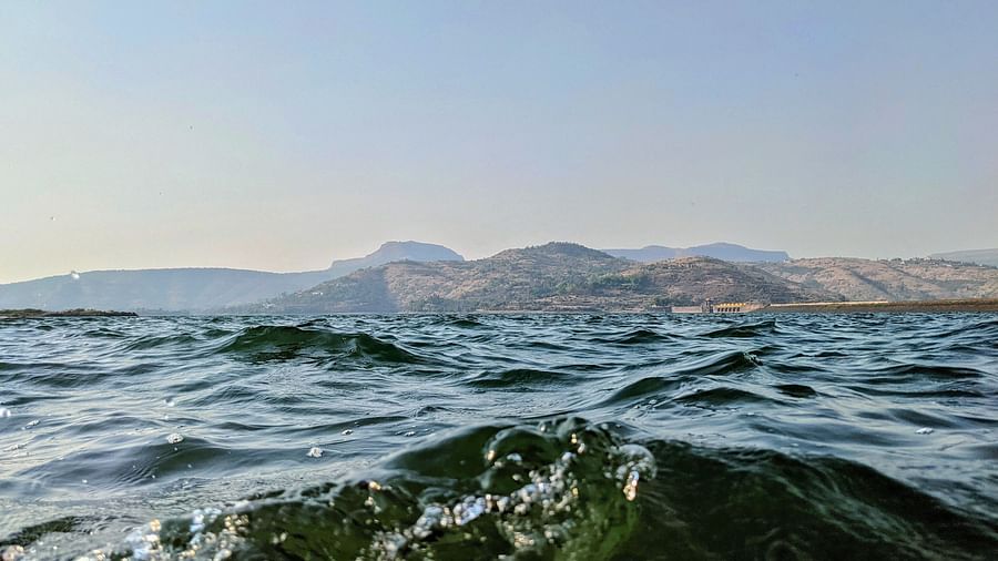 an image of Pawna lake with a close-up shot during the day showcasing the crystal clear water 