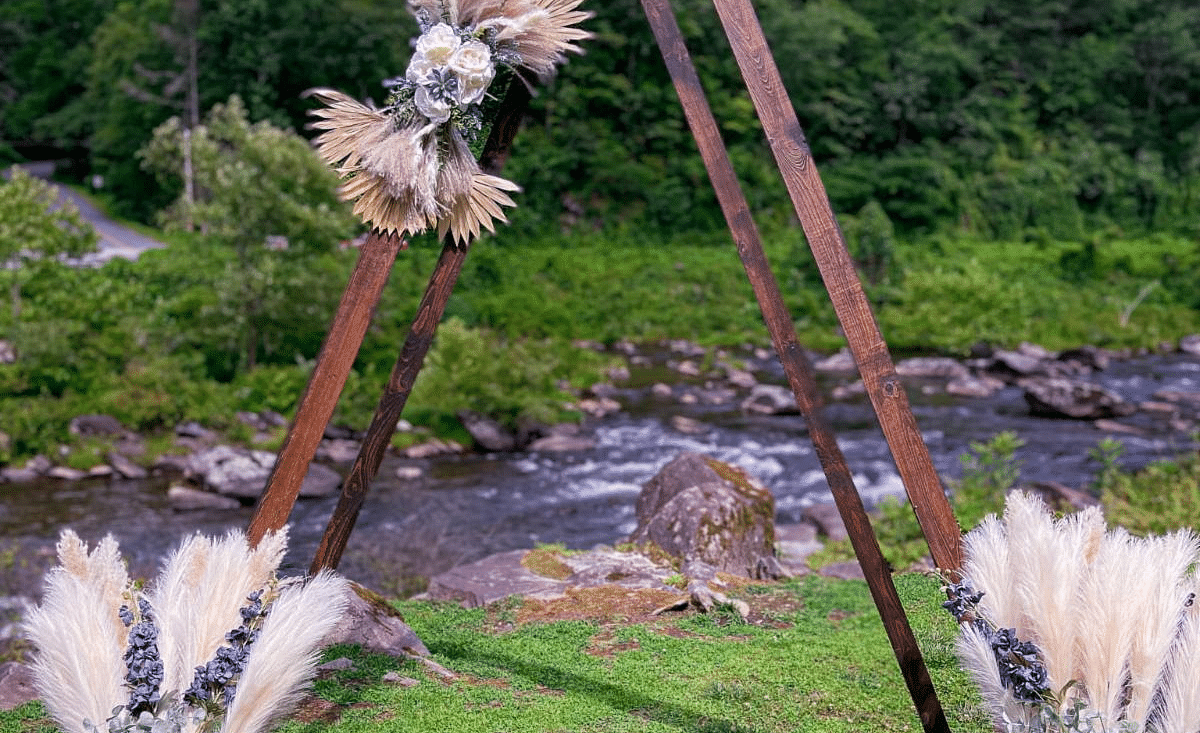 a wooden structure besides the river with flowers kept near the structure for decoration