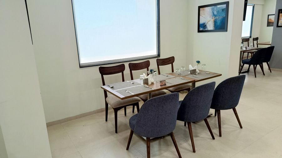 Seating arrangement inside the restaurant 3 - Starlit Suites, Shirdi