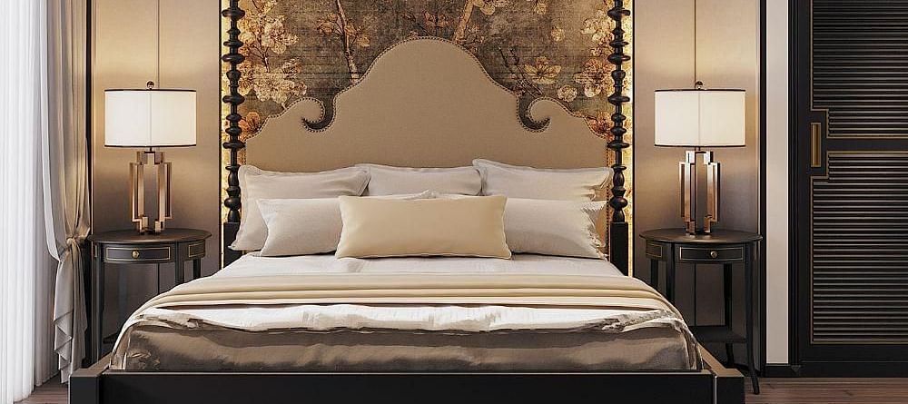 Front view of a well-made bed with cushions, a ceiling fan, and two bedside tables with lamps at The Evren, Vagator.