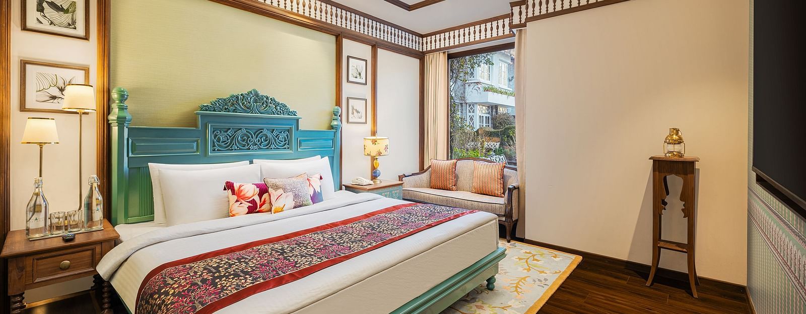 A premium suite in Naini retreat, Nainital, with a king-size bed, headboard, The room features a ceiling fan, wooden flooring, and a large window with natural light.