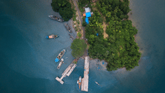 An aerial view of Port Blair with boats, trees and a road in view