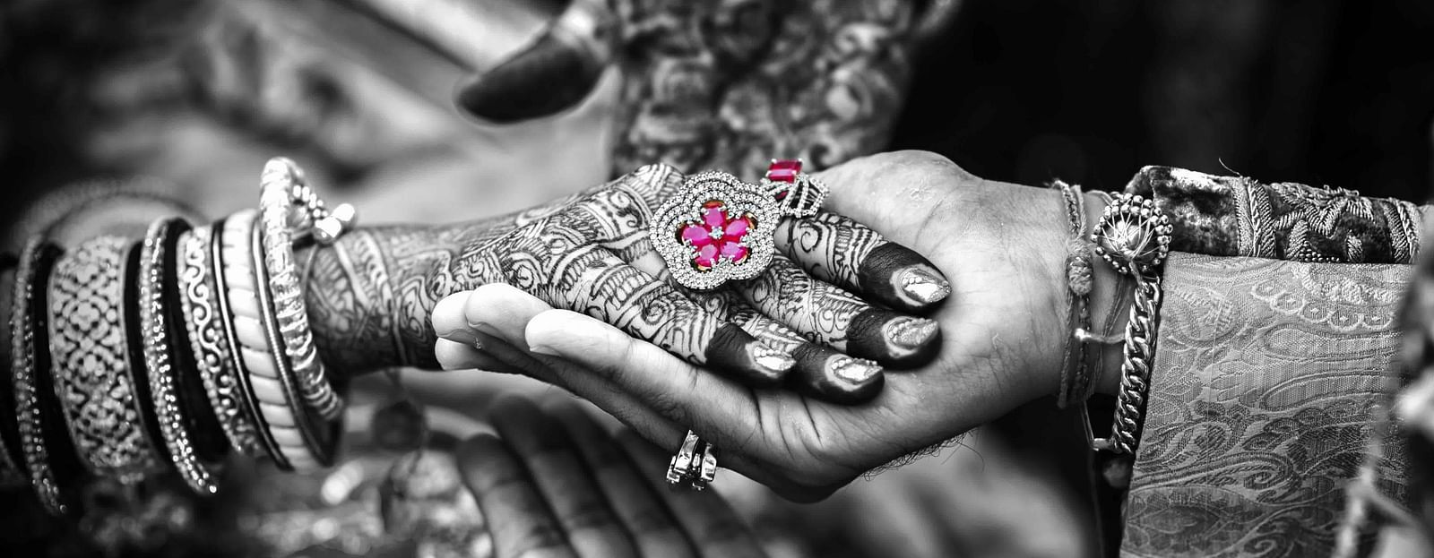 An image of a bride holding hands of a groom during a wedding ceremony