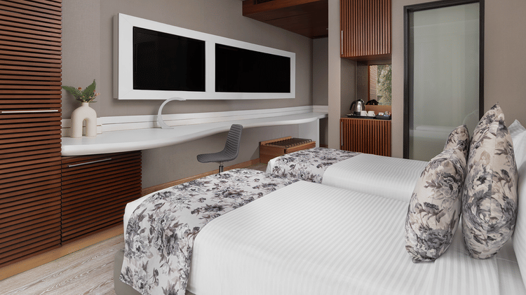 Modern room at The Atara, Gurugram featuring two beds, wall-mounted TV, and a desk. The room features warm wood accents and light-coloured walls