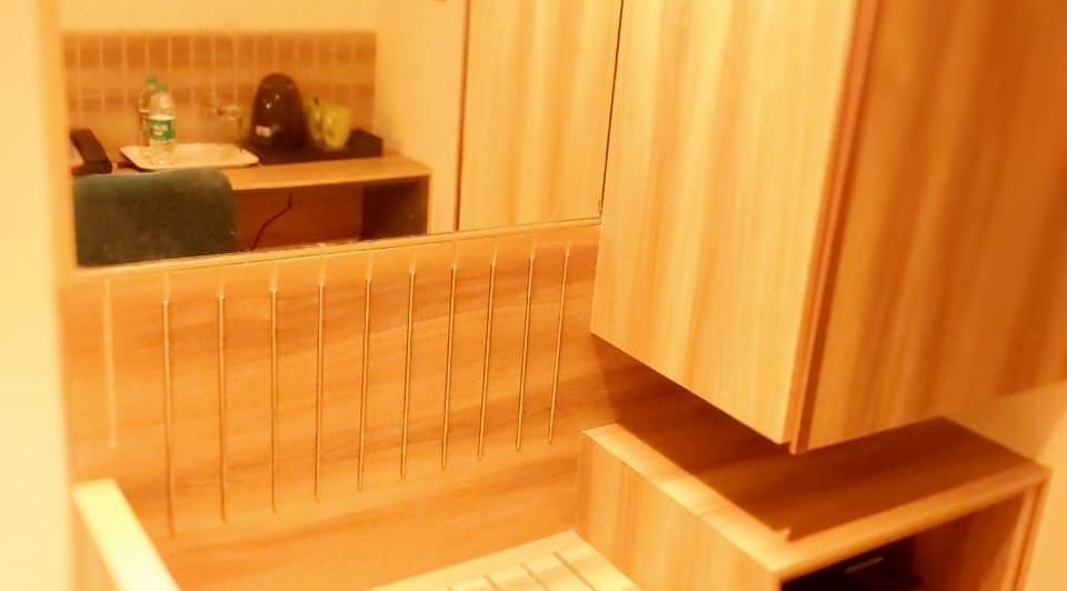 Room with wardrobe and a lookimg glass at Hotel Raai, Hosur.