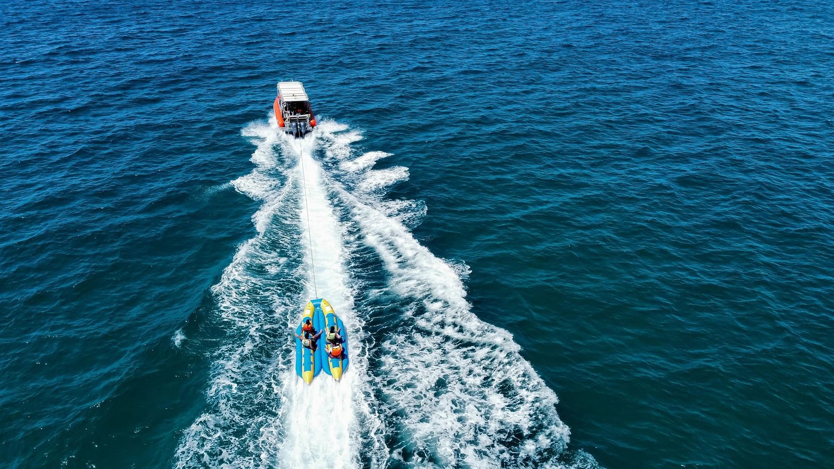 A group of people in a banana boat ride on the water