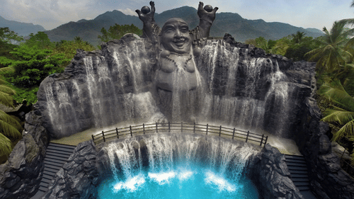 A majestic water fountain with cascading waterfalls and a sculpted face, creating a tranquil and impressive display in a lush setting - The Black Thunder