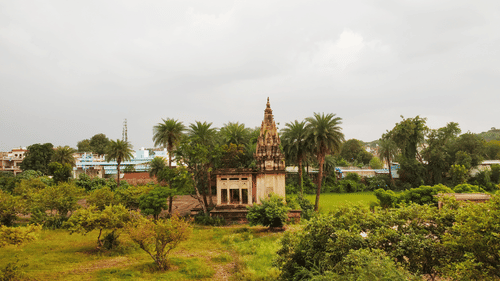 a grassland with a building in the middle