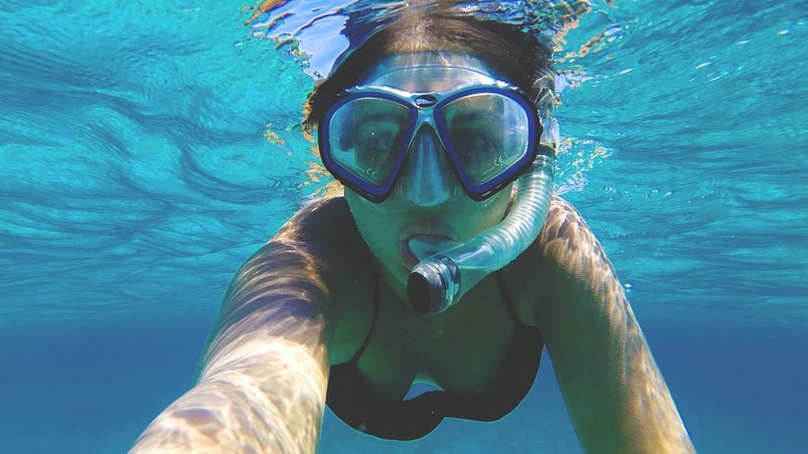 a woman snorkelling in a swimming pool