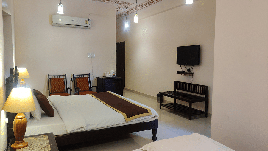 A double and a single bed in the Deluxe double room at Suryaa Villa Jaipur