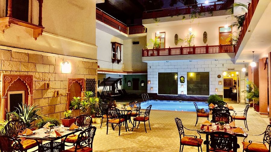 Seating arrangement at Poolside Courtyard Dining at Suryaa Villa Jaipur