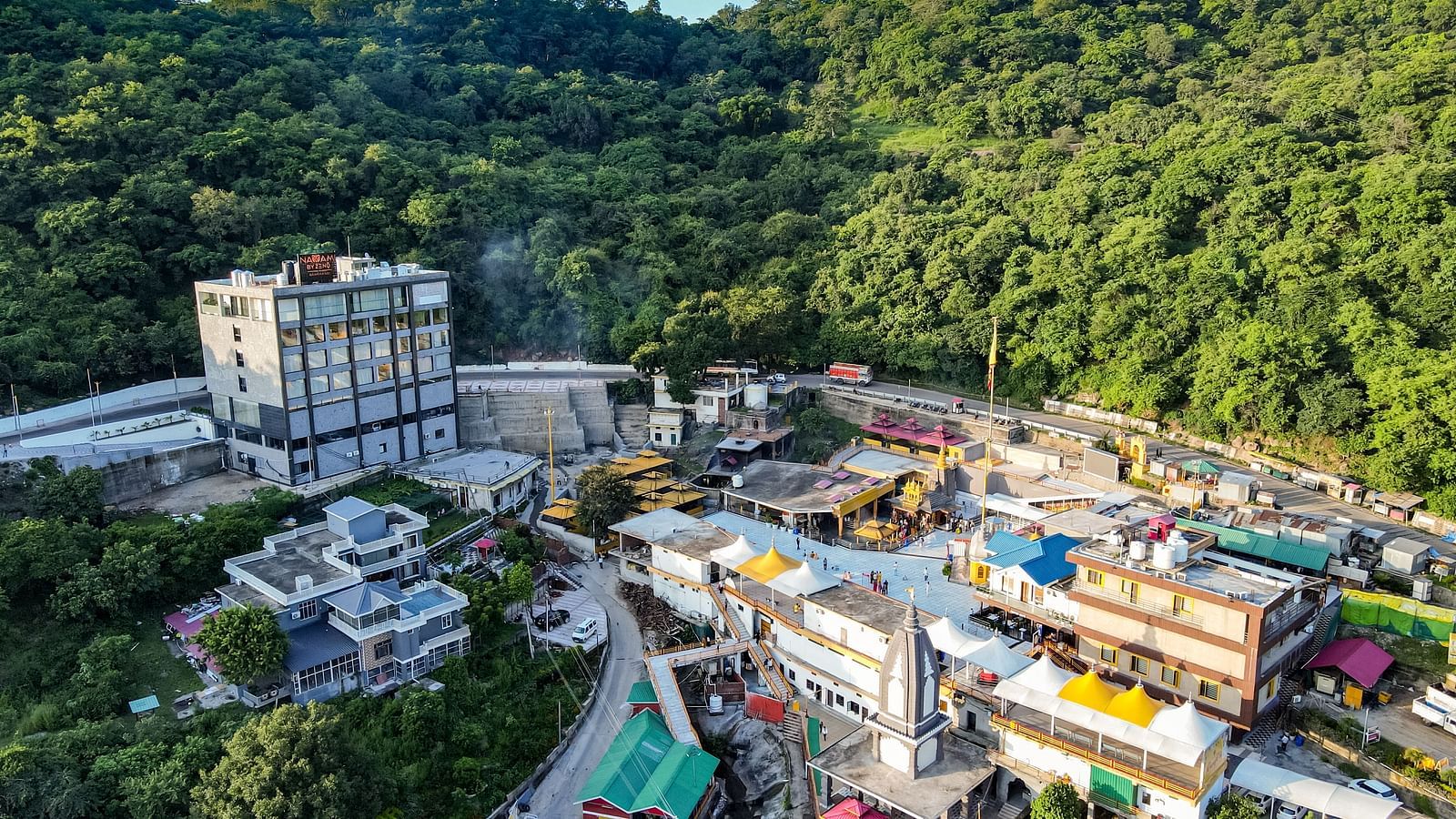 An image of our hotel building with vibrant mountains surrounding it - NAMAMI BY ZENQ BANKHANDI