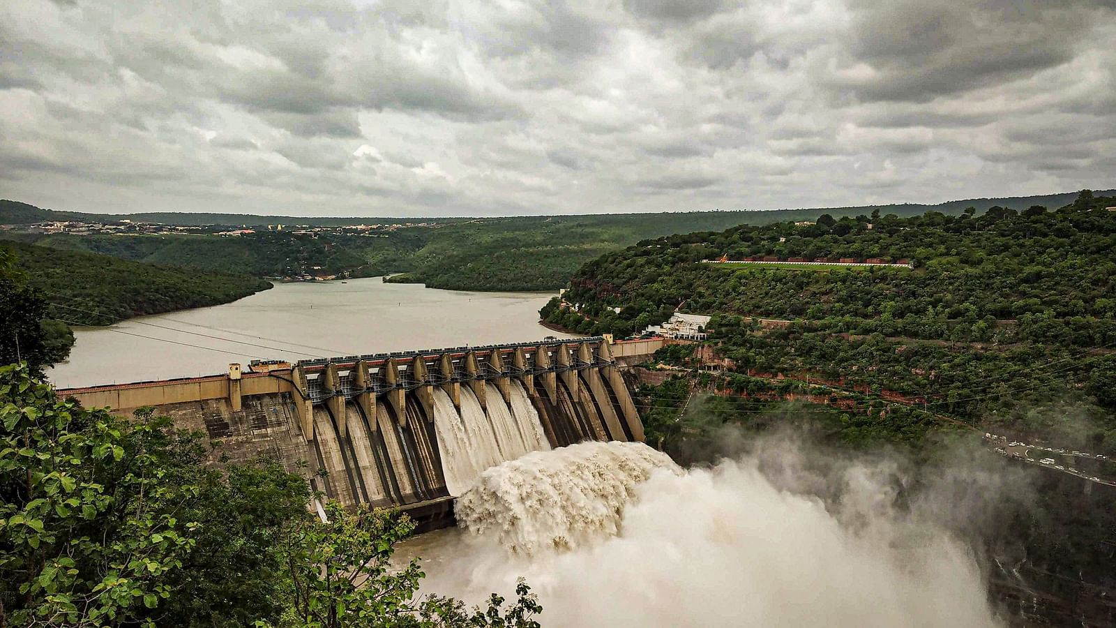 an overview of a damn with water gushing down