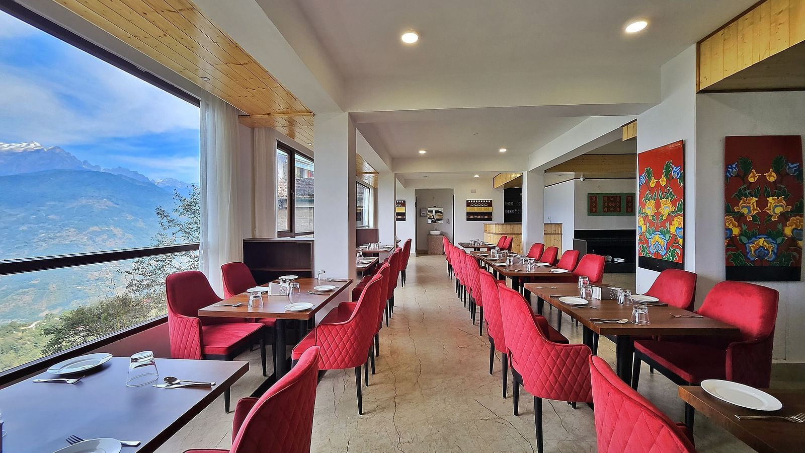 dining setting of a restaurant with red chairs at Sumitel Pelling, Geyzing