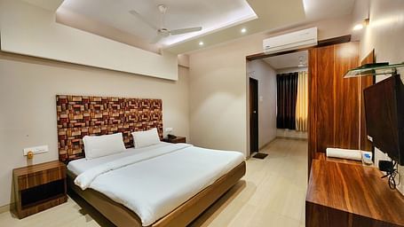 A Premium Room at The Kanila Resort featuring a bed, a desk, and a wardrobe.