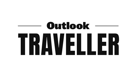A logo of the Outlook Traveller