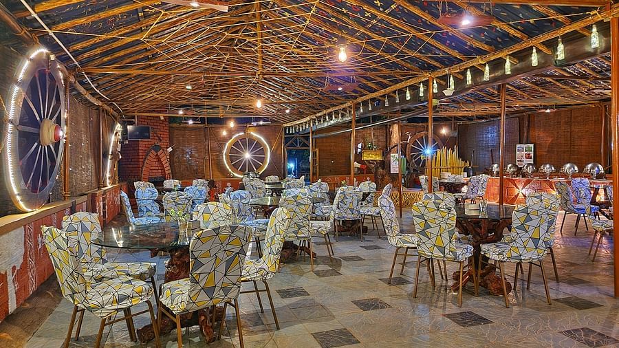 Spacious restaurant interior under a bamboo roof, featuring a buffet area and eclectic seating - Evergreen County