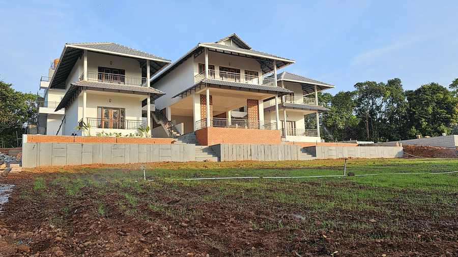 Wide-angle view of a modern homestay overlooking the picturesque countryside.