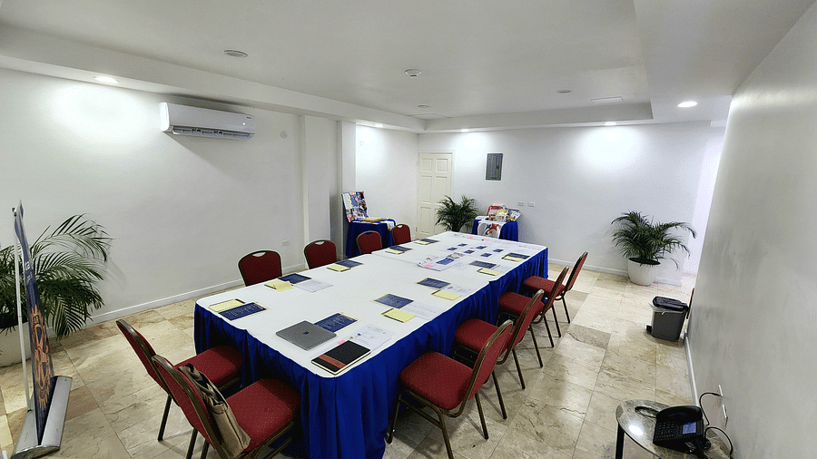 A clean, modern meeting space in Montego Bay with red chairs and a white conference table - Hotel 39, Jamaica (Montego Bay)