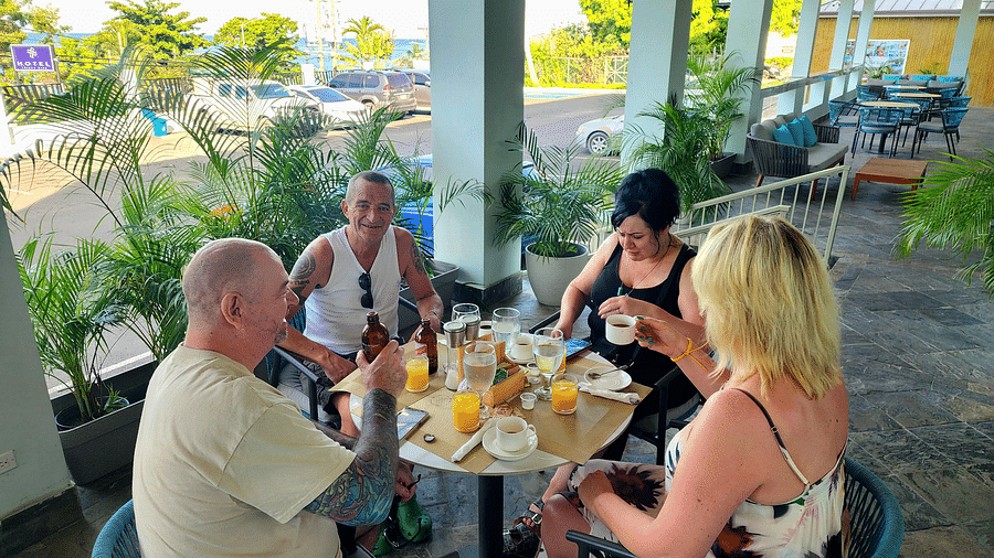 Guests enjoying an outdoor meal at a shaded dining area at Alexander Dining in montego bay, jamaica - Hotel 39, Jamaica