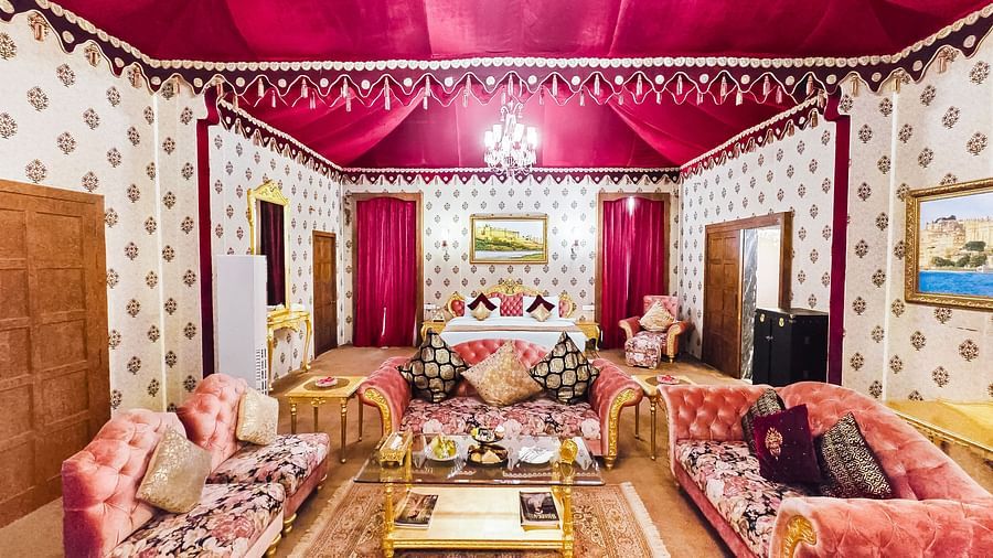 An overview of a room with a bed in the background and seating arrangements in front of it - Rajasthali Resort & Spa, Jaipur.