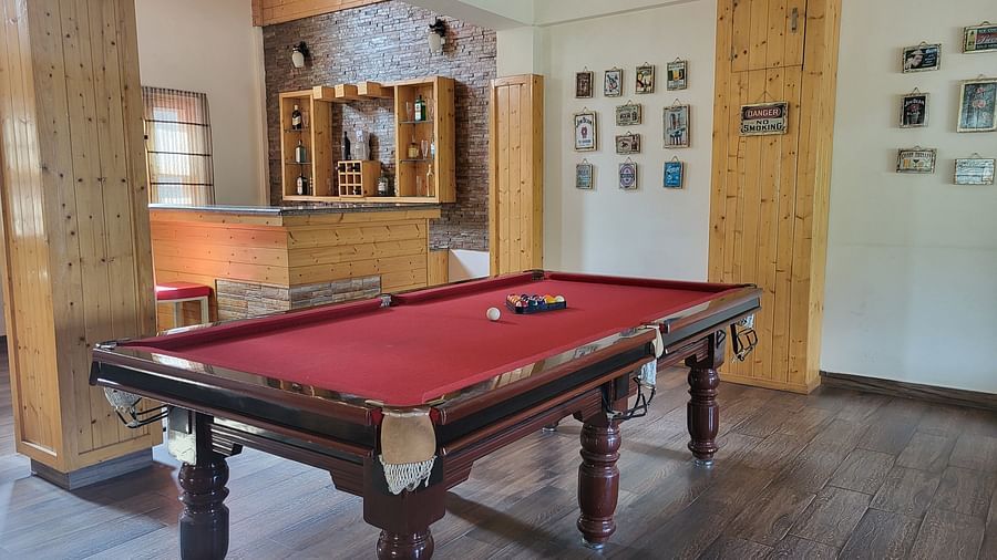 An area featuring a classic wooden pool table at Dagshai Manor Kasauli - Inde Hotels.