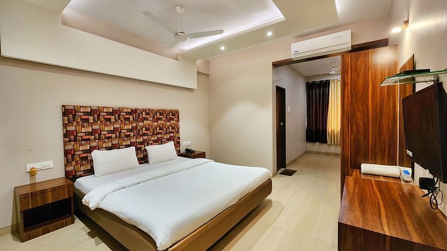 A Premium Room at The Kanila Resort featuring a bed, a desk, and a wardrobe.