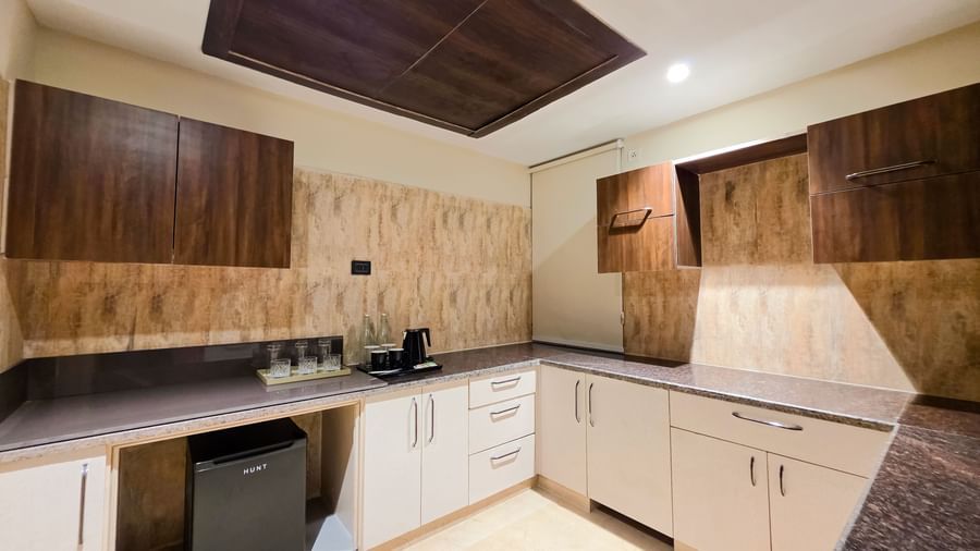 A separate kitchen area featuring the empty slabs and modern cabinets at The Meriton.