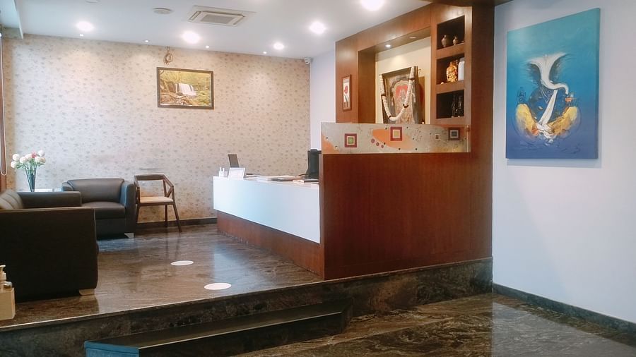 Mysore Gate Hotel, Bangalore Bengaluru A reception area featuring a booking counter a waiting space with sofas and a table - Mysore Gate Hotel Bangalore