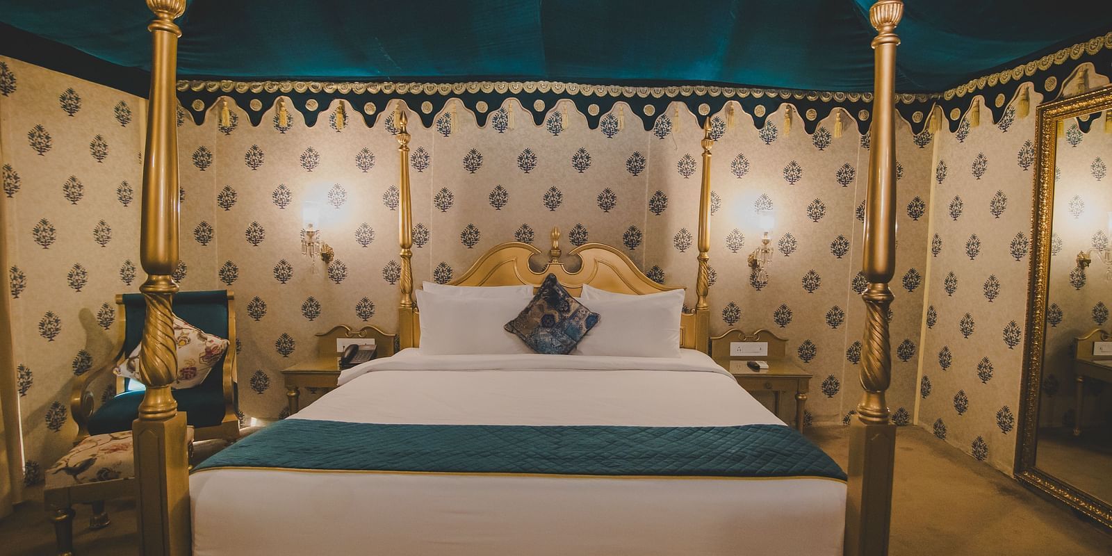 Front view of Royal Luxury Tent with Balcony with a bed that has a metal frame at Rajasthali Resort and Spa.